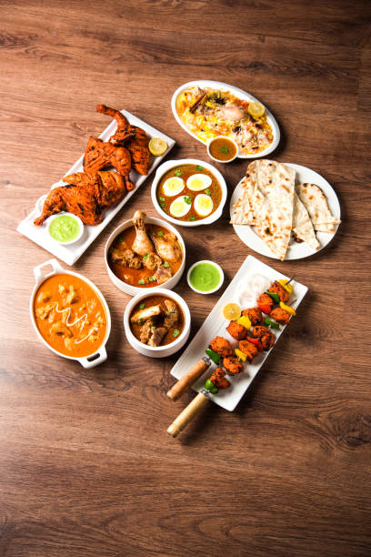 istock Assorted Indian Non Vegetarian food recipe served in a group. Includes Chicken Curry, Mutton Masala, Anda/egg curry, Butter chicken, biryani, tandoori murg, chicken-tikka and naan/roti 1169694945