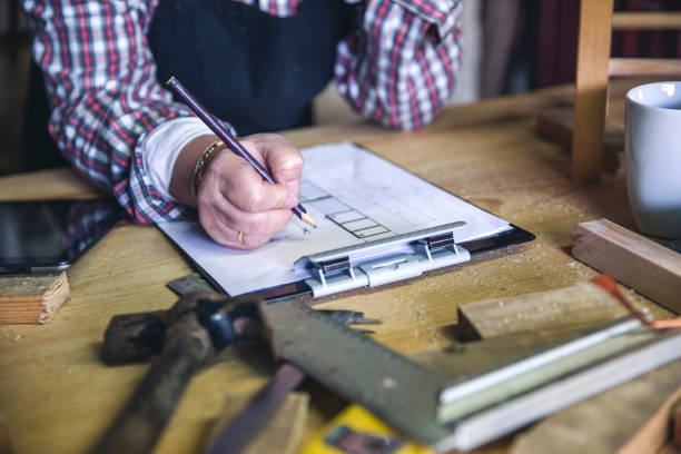 istock Female carpenter in her workshop 1169694948