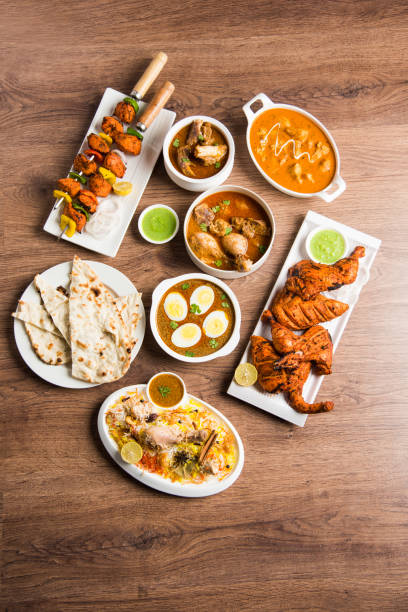 istock Assorted Indian Non Vegetarian food recipe served in a group. Includes Chicken Curry, Mutton Masala, Anda/egg curry, Butter chicken, biryani, tandoori murg, chicken-tikka and naan/roti 1169695660