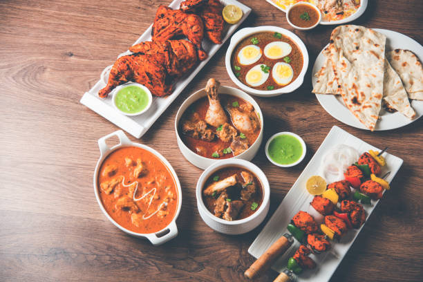 istock Assorted Indian Non Vegetarian food recipe served in a group. Includes Chicken Curry, Mutton Masala, Anda/egg curry, Butter chicken, biryani, tandoori murg, chicken-tikka and naan/roti 1169695742