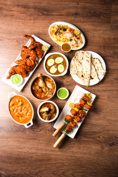 istock Assorted Indian Non Vegetarian food recipe served in a group. Includes Chicken Curry, Mutton Masala, Anda/egg curry, Butter chicken, biryani, tandoori murg, chicken-tikka and naan/roti 1169695834