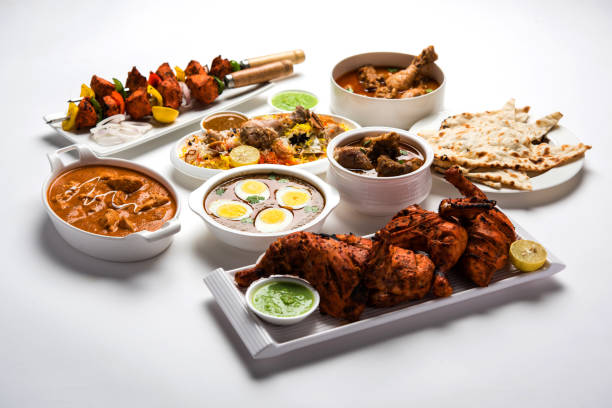 istock Assorted Indian Non Vegetarian food recipe served in a group. Includes Chicken Curry, Mutton Masala, Anda/egg curry, Butter chicken, biryani, tandoori murg, chicken-tikka and naan/roti 1169697916