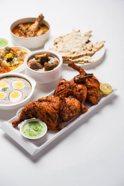 istock Assorted Indian Non Vegetarian food recipe served in a group. Includes Chicken Curry, Mutton Masala, Anda/egg curry, Butter chicken, biryani, tandoori murg, chicken-tikka and naan/roti 1169698052