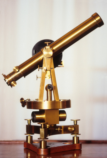 Elderly man observing the sky with a telescope isolated on white background
