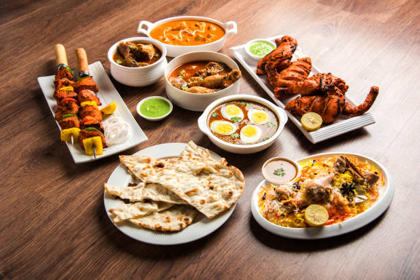 istock Assorted Indian Non Vegetarian food recipe served in a group. Includes Chicken Curry, Mutton Masala, Anda/egg curry, Butter chicken, biryani, tandoori murg, chicken-tikka and naan/roti 1169700146