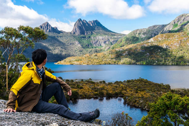 Trekking in Tasmania, Australia. Traveller man explore landscape of Marions lookout trail in Cradle Mountain National Park in Tasmania, Australia. Summer activity and people adventure. hiking in tasmania stock pictures, royalty-free photos & images