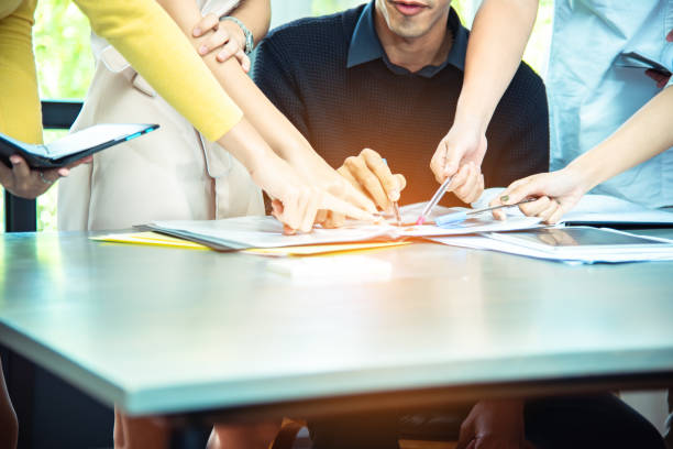 istock Teamwork business concept .Start up business people in modern office, working together having success. Multiethnic start-up business team on meeting in modern bright office interior brainstorming 1169701438