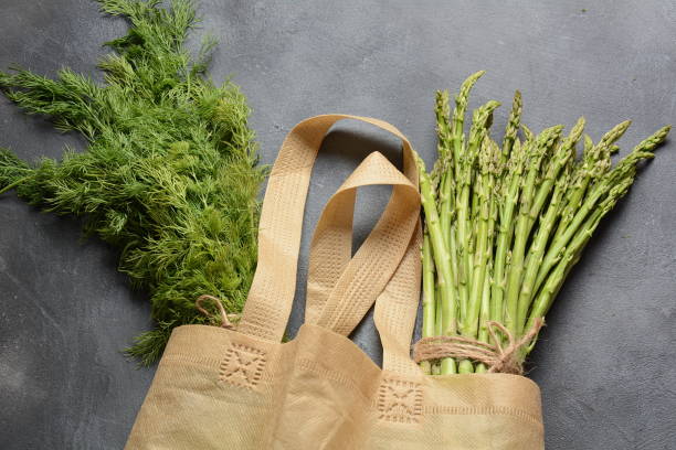 istock Reusable zero waste textile product bag with green asparagus 1169701470
