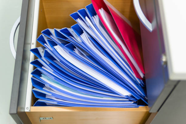 istock blue file folder documents In a file cabinet retention of contracts 1169703537