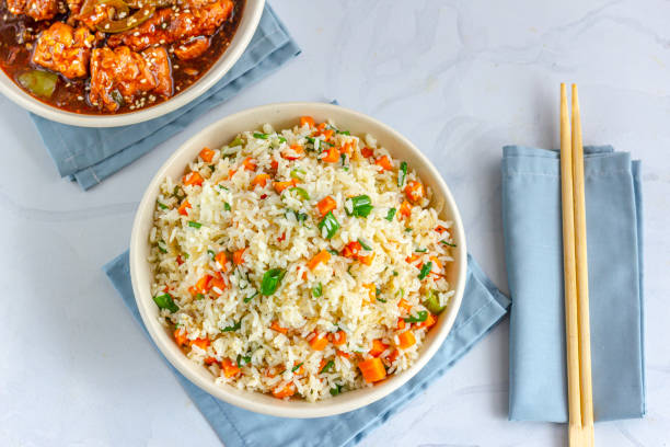 Chinese Fried Rice with Chicken Side Dish Directly Above Photo Chinese Vegetable Fried Rice in a Bowl with SIde Dish Top View Photo. Vegetable Fried Rice with Chicken Side Dish Top View Photo."n fried rice stock pictures, royalty-free photos & images