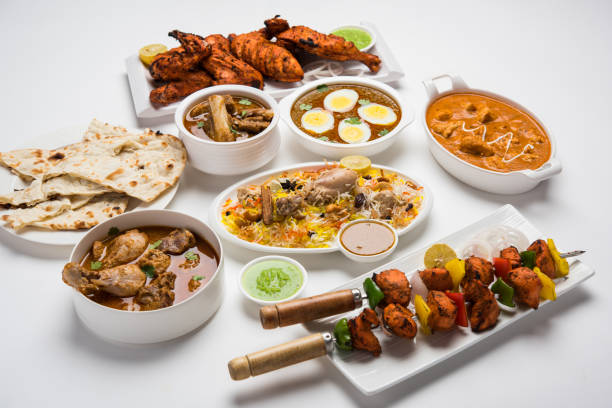 istock Assorted Indian Non Vegetarian food recipe served in a group. Includes Chicken Curry, Mutton Masala, Anda/egg curry, Butter chicken, biryani, tandoori murg, chicken-tikka and naan/roti 1169704363