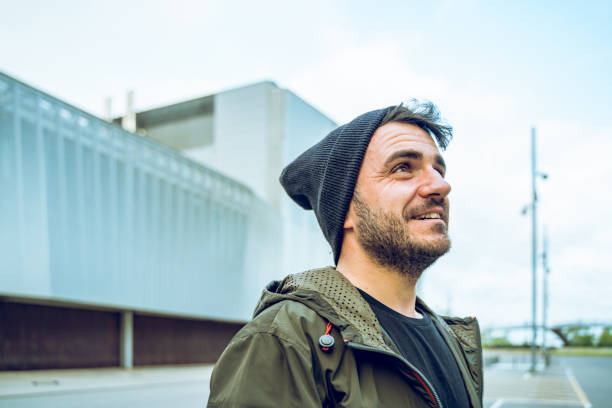 istock Cheerful man with a wool hat at the street 1169705116