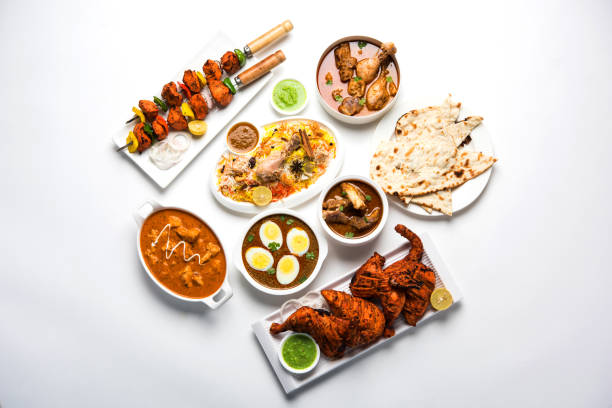 istock Assorted Indian Non Vegetarian food recipe served in a group. Includes Chicken Curry, Mutton Masala, Anda/egg curry, Butter chicken, biryani, tandoori murg, chicken-tikka and naan/roti 1169705130
