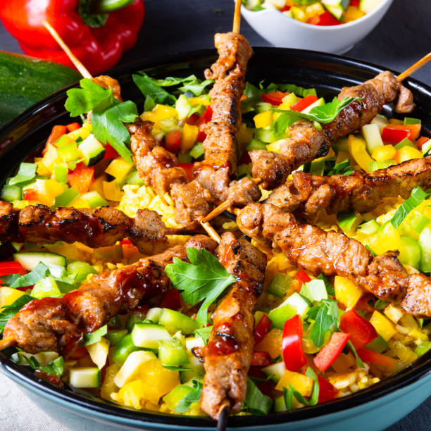 istock Lamb skewers with curry rice and different vegetables 1169705347
