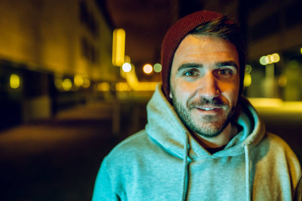 istock Casual man wearing a wool hat and a sweater at night 1169706001