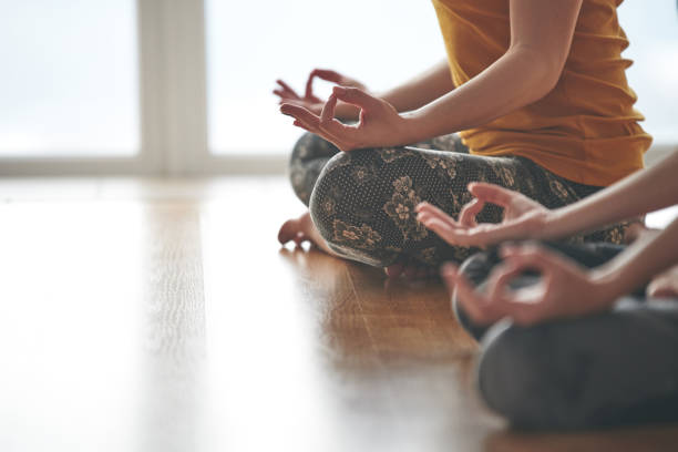 istock Two woman doing yoga flow in studio 1169706960