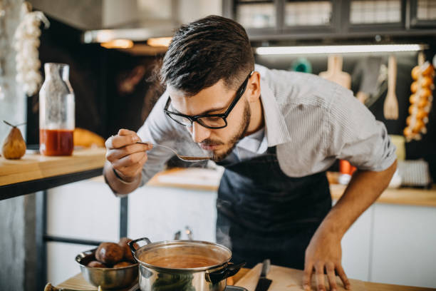 istock Man tasting his food before serving it 1169708326
