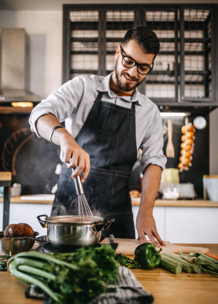 istock Man mixing food 1169709918
