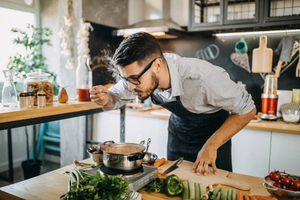istock Man tasting his food before serving it 1169709955