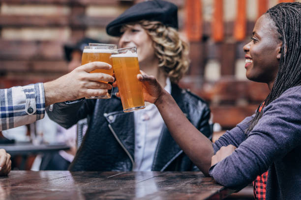istock Friends celebrating in pub 1169710113