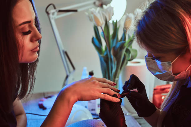 istock Manicurist paints the nails to the client 1169711270
