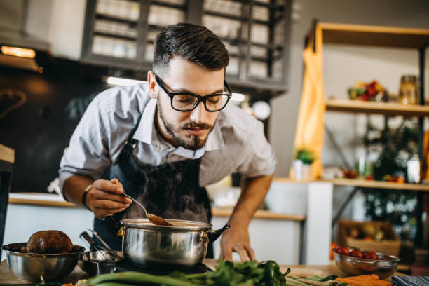 istock Man tasting his food before serving it 1169711613