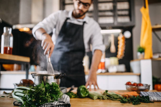 istock Man mixing food 1169713502