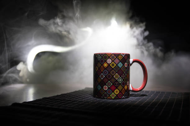 istock Beautiful eastern style textured ceramic cup of coffee (or tea) with smoke over dark toned background. 1169715370