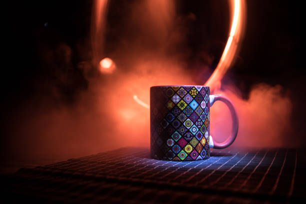 istock Beautiful eastern style textured ceramic cup of coffee (or tea) with smoke over dark toned background. 1169715378