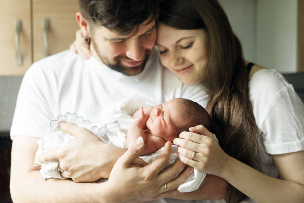 Father and mother with a newborn son. New multi-generation young family Father and mother with a newborn son. New multi-generation young family. cute pregnant woman with gift stock pictures, royalty-free photos & images