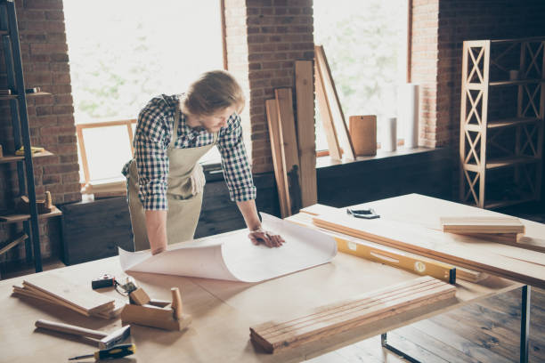 istock Portrait of his he nice attractive handsome blond focused guy artisan builder reading drafts creating projects at industrial brick loft style interior indoors workplace studio 1169717816