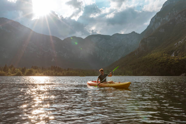 istock Young man kayaking in the lake 1169718464