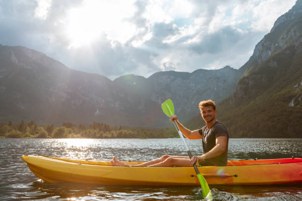 istock Young man kayaking in the lake 1169718466