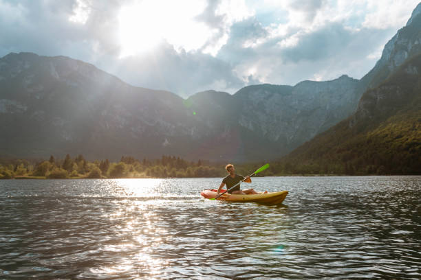 istock Young man kayaking in the lake 1169718498