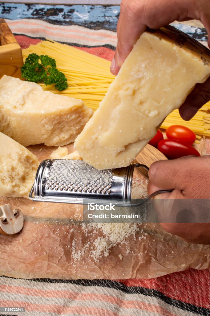 https://media.istockphoto.com/id/1169722141/photo/man-cooking-with-hard-italian-cheese-grated-parmesan-or-grana-padano-cheese-hand-with-grater.jpg?s=1024x1024&w=is&k=20&c=EJMXJFuW5WcYXSuWx0oi-6W6eIdvpfB7yvTXdPqyEQg=