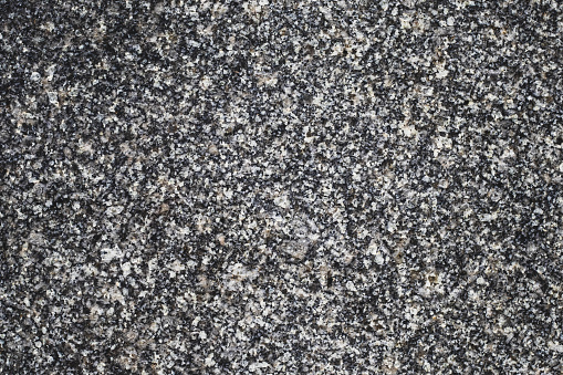 Black stone wall texture. Granite slab surface. Abstract background, quartz pattern. Grunge gray tile. Copy space