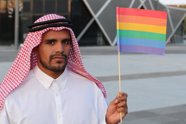 istock Attractive Arabic gay man holding the rainbow flag 1169724698