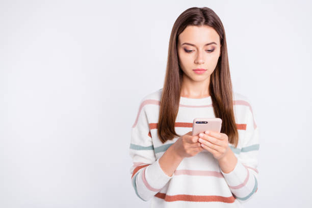 istock Pretty lady with telephone in hands wear striped fluffy pullover isolated white background 1169724782