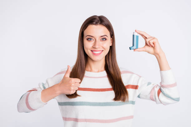 istock Pretty lady offering to use bronchospasm cartridge aerosol wear striped pullover isolated white background 1169724849