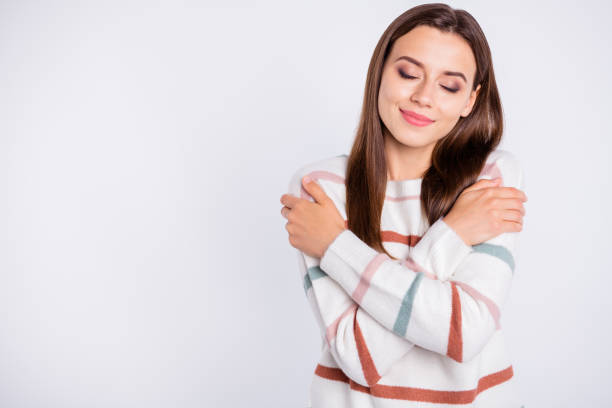 istock Photo of overjoyed lady crossing hands touching nice striped pullover isolated white background 1169725034