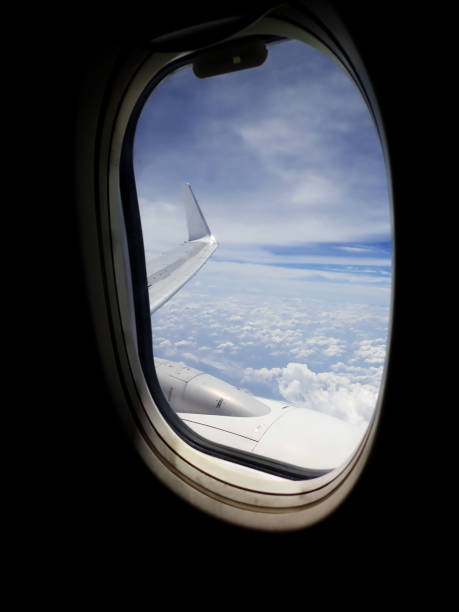 istock Stunning and beautiful view looking through window aircraft during flight in wing with a nice blue sky around the South China Sea.. 1169727360