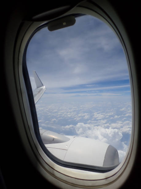 istock Stunning and beautiful view looking through window aircraft during flight in wing with a nice blue sky around the South China Sea.. 1169727388