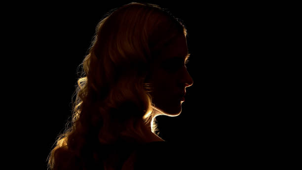 istock Seductive blond lady looking to side, isolated on black background, mystery 1169727745