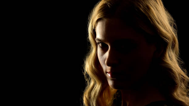 istock Devil woman looking at camera, black background, paranormal mystery, white eyes 1169727751