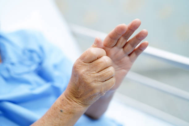 asian senior or elderly old woman patient pain trigger finger lock her hand while sitting on bed in nursing hospital ward : healthy strong medical concept. - finger on the trigger imagens e fotografias de stock