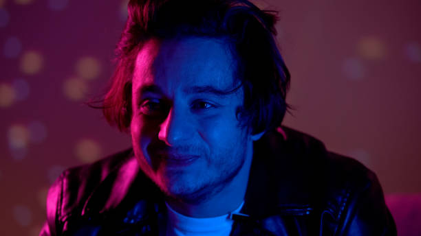 istock Drunk man smiling in night club, relieving stress after busy working week 1169728886