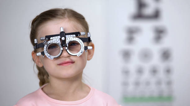 istock Little girl wearing eye testing glasses to diagnose vision, professional help 1169729167