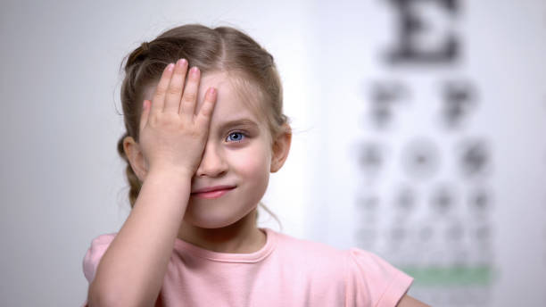 istock Child girl closing eye, showing size or sign from eye chart, vision diagnostics 1169729207