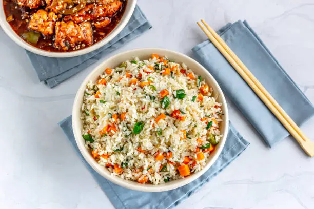 Chinese Vegetable Fried Rice in a Bowl with Side Dish Top View Photo..
