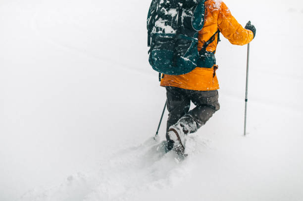 Man exploring mountain, hiking with backpack on his back